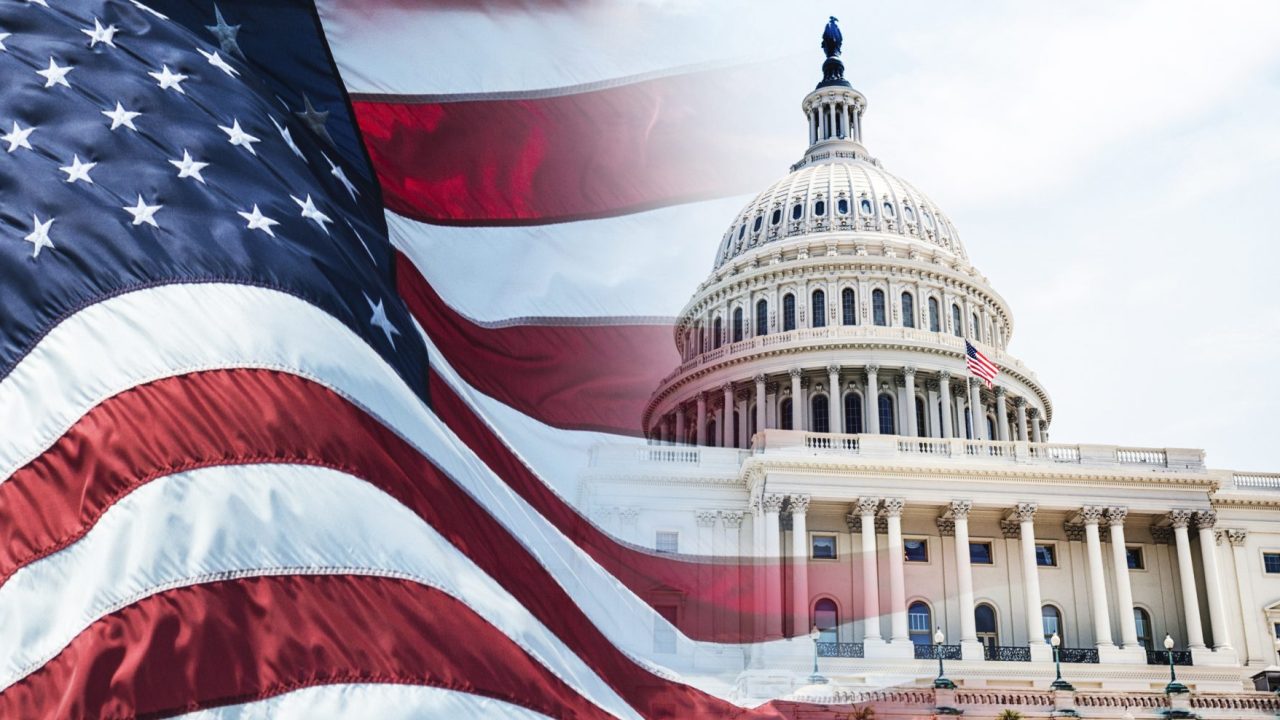 United States flag flying in front of the capitol building
